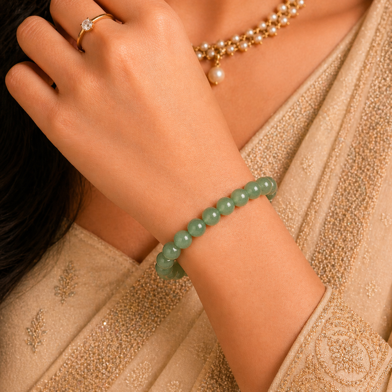 Close-up of a women wearing a green aventurine bracelet