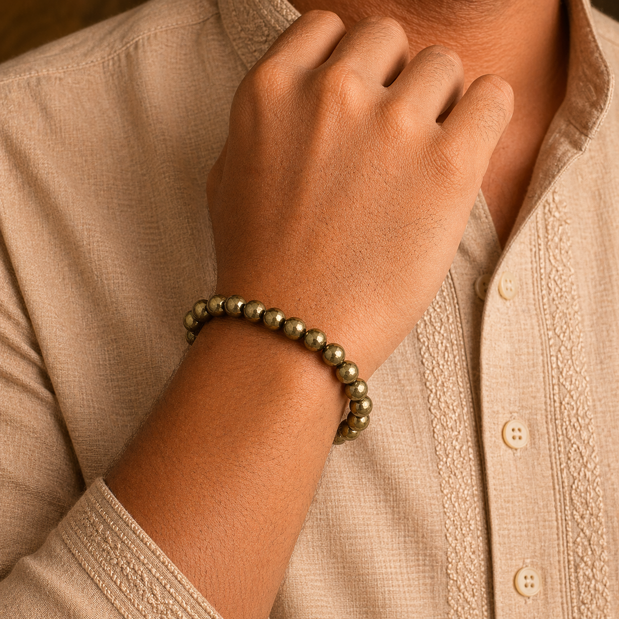 Man wearing a pyrite bracelet on a person