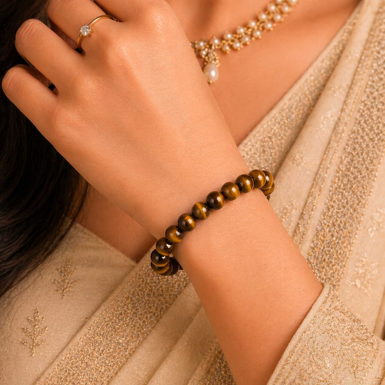 Close-up of a hand wearing a tigers eye bracelet